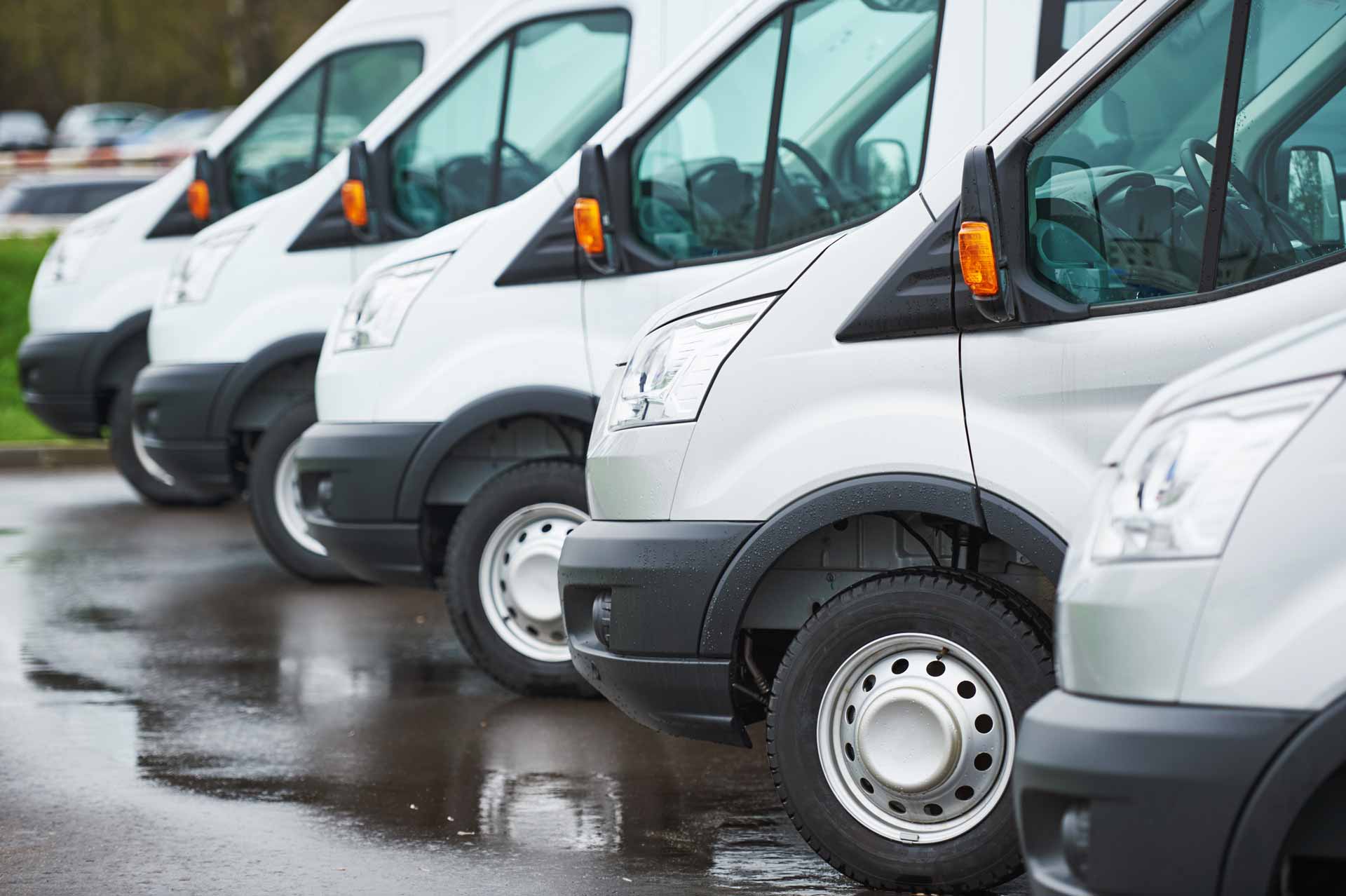 Fleet of identical white commercial vans