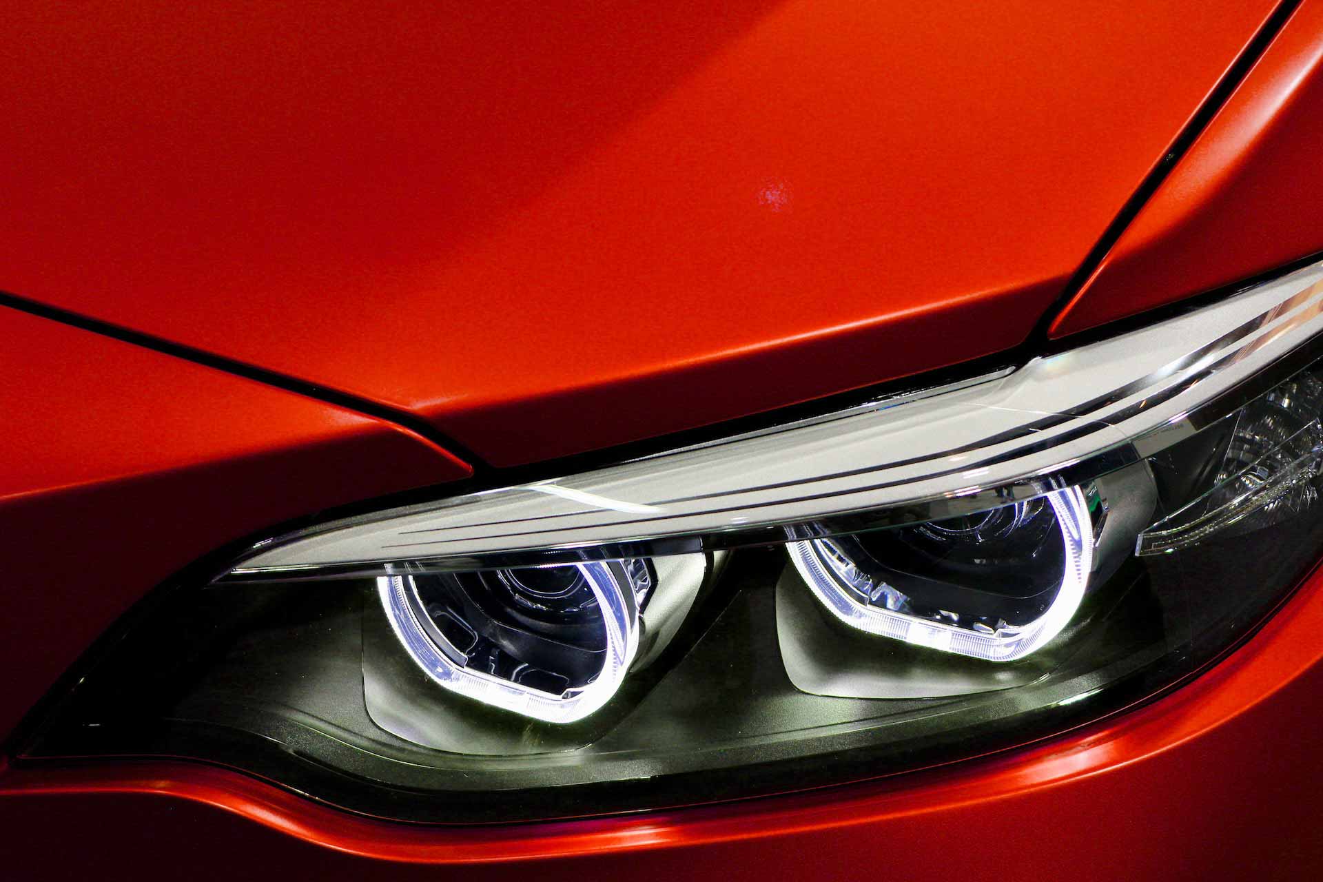 Close up on LED headlights on red car
